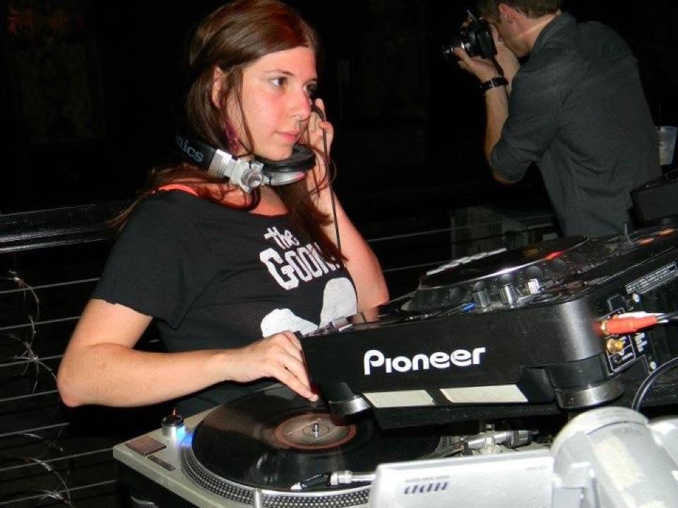 Brittany mixing vinyl behind the decks